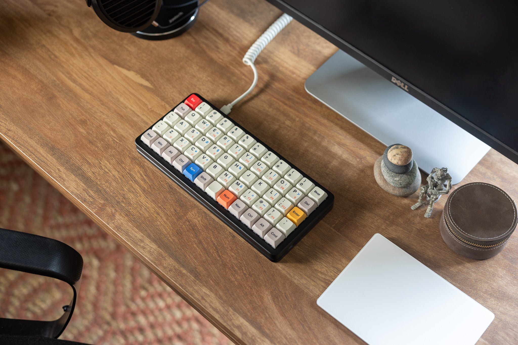 Preonic Rev 4 on a wooden desk next to a monitor and headphones